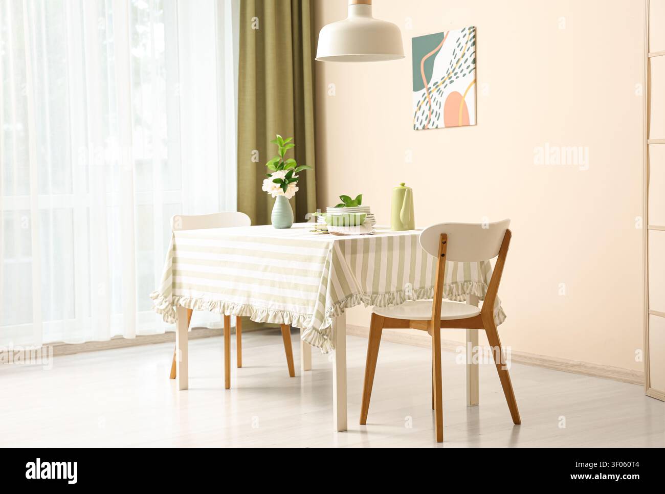 Bright dining room with table set and modern chairs Stock Photo