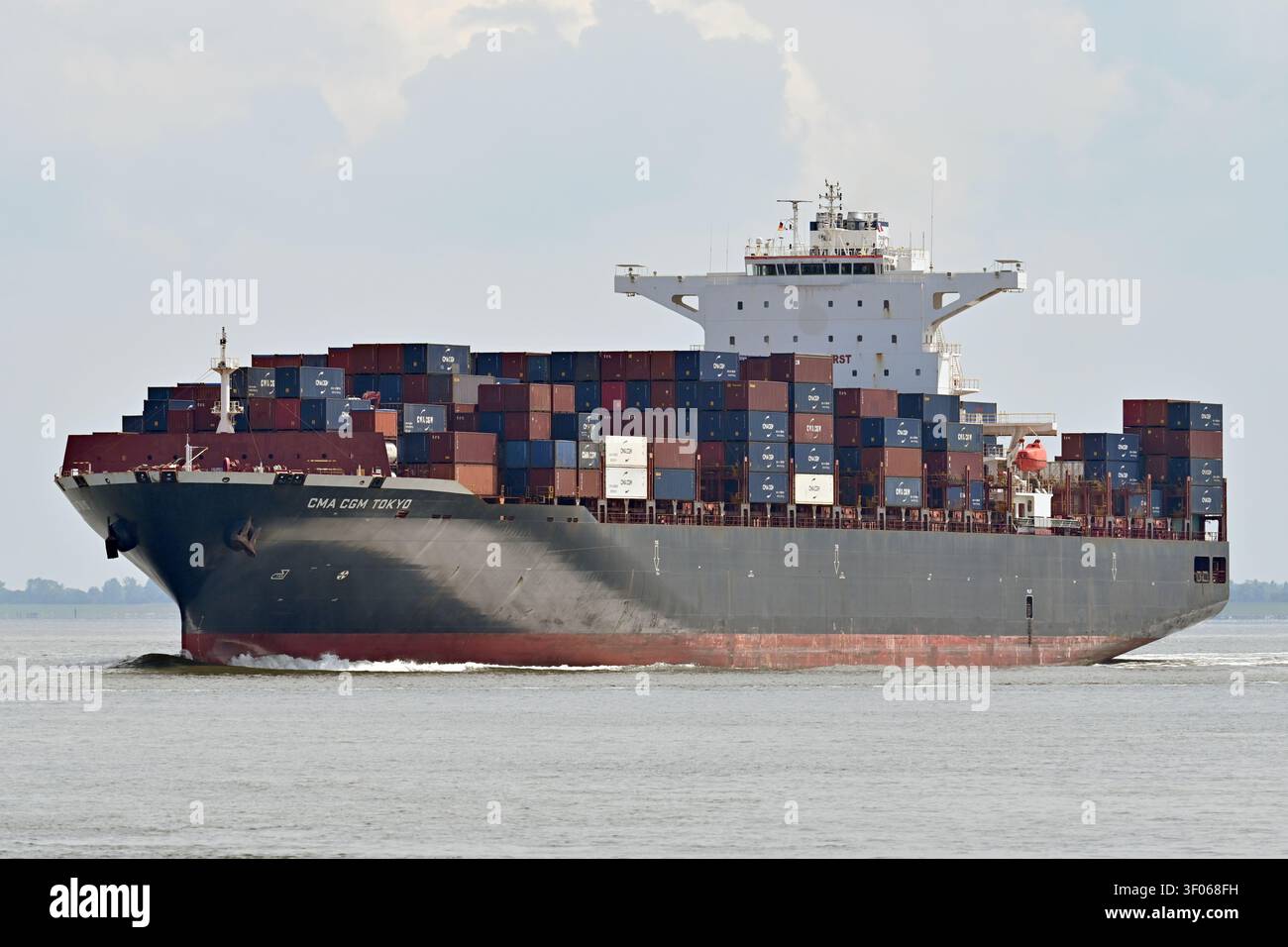 Containership CMA CGM TOKYO passing Cuxhaven Stock Photo