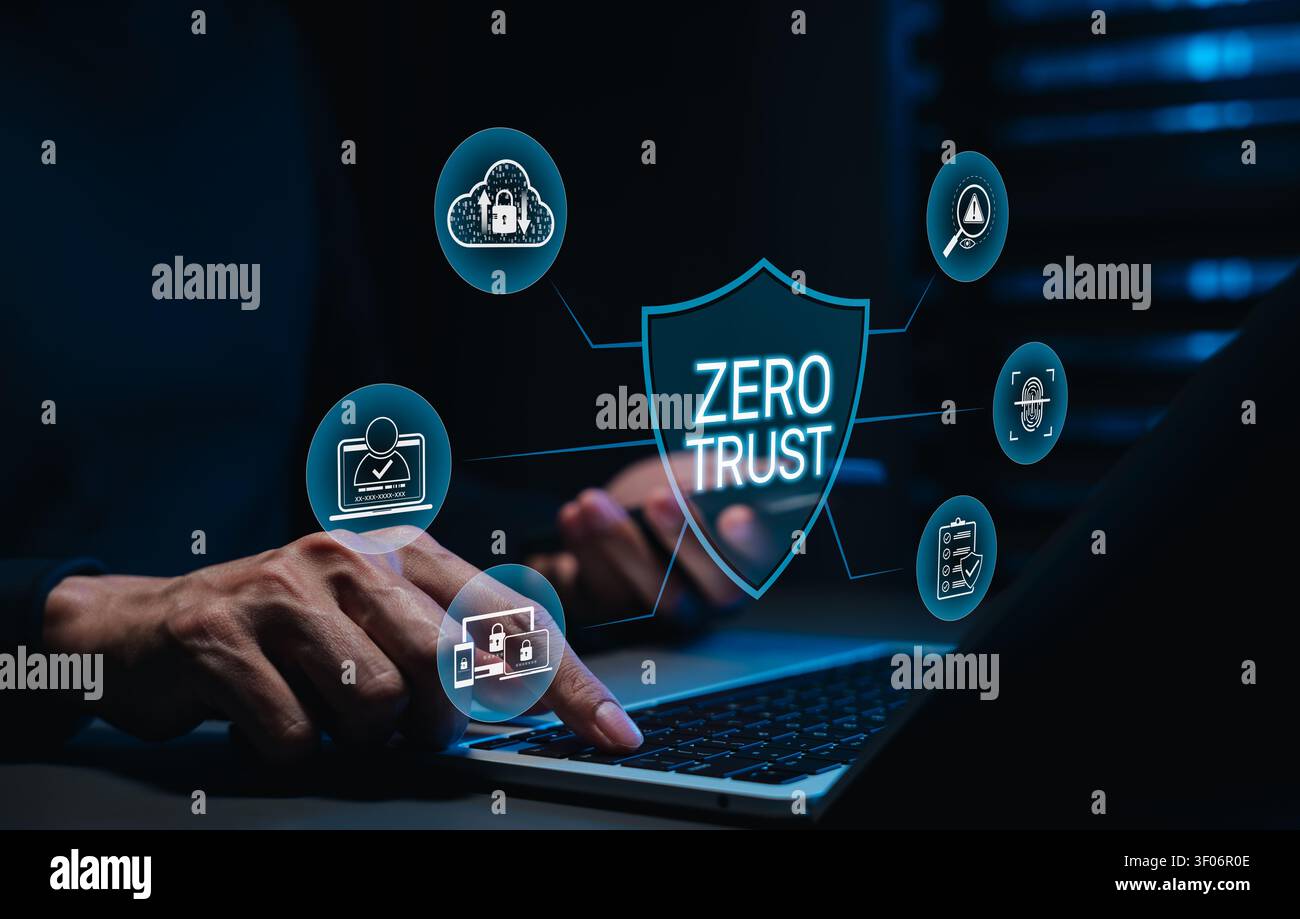 Zero trust cybersecurity concept. Man using laptop with shield protection, identity access management, cloud security, fingerprint verification Stock Photo