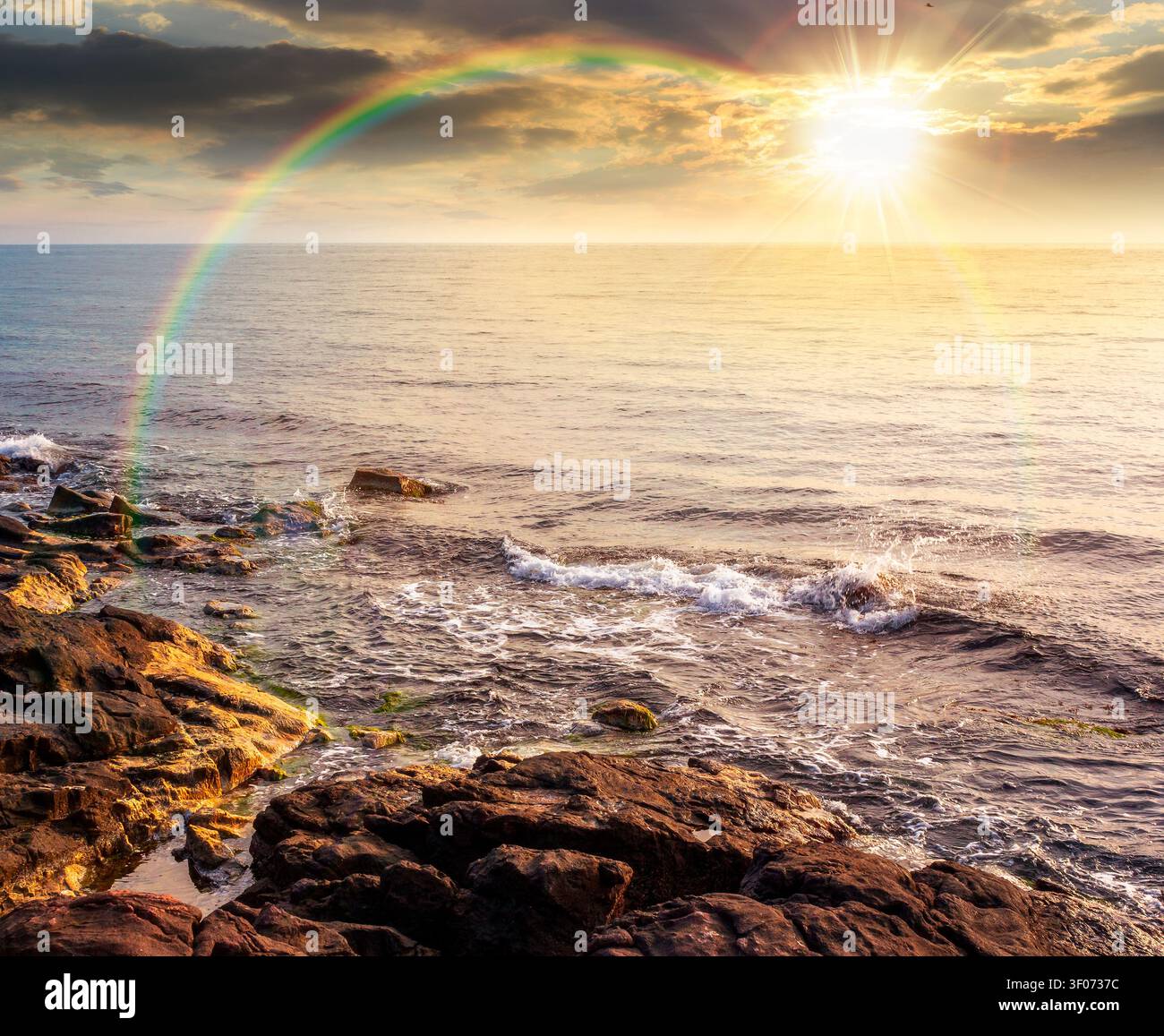 sunset over sea coast with stones and rocks. summer vacation background. seascape with rough terrain. relaxing at the sea. coast of bulgaria. weather Stock Photo
