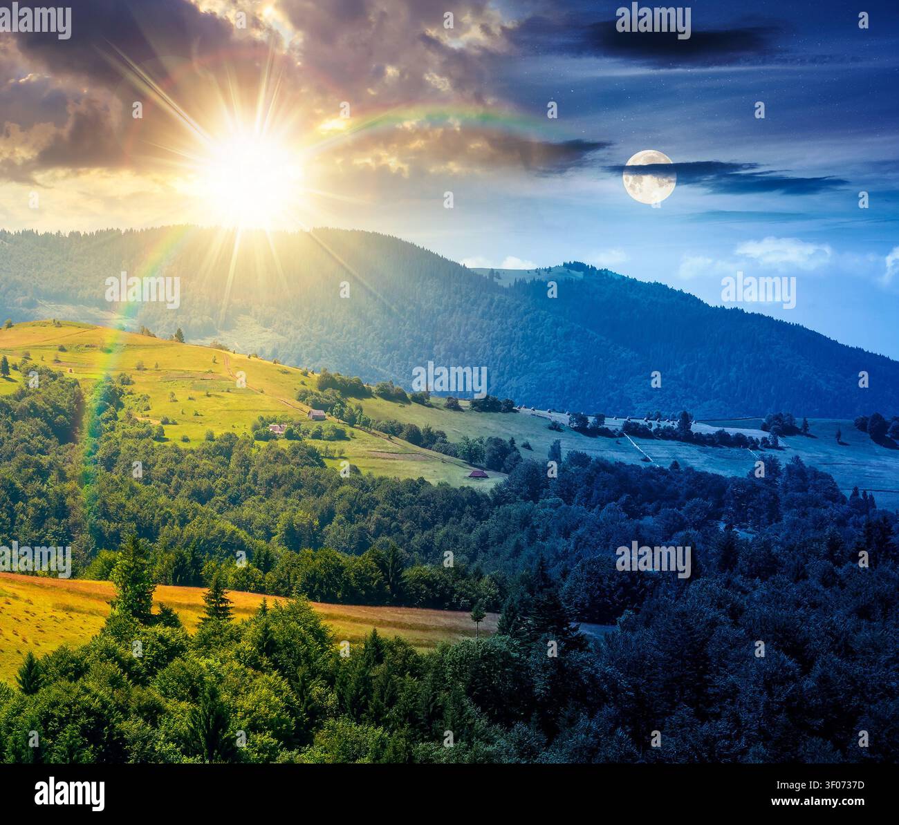 agricultural field on hillside in mountains near village. day meet night. summer solstice. sun and moon in harmony over green carpathian mountain land Stock Photo