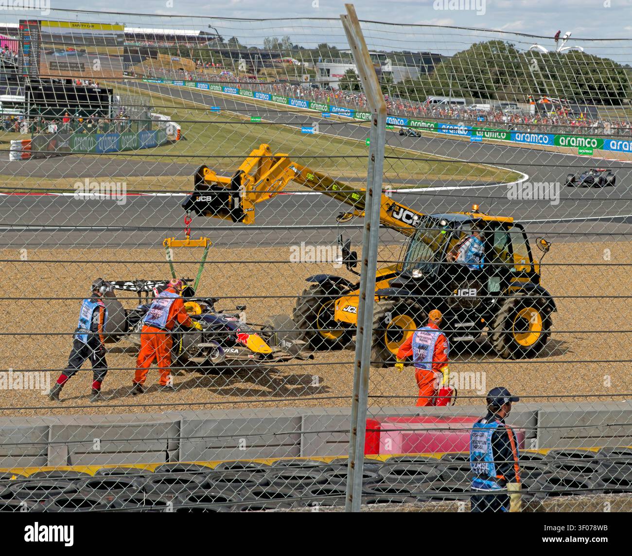 JCB recovers Max Verstappen’s Red Bull in front of the Landostand gravel trap after his Silverstone F1 crash issues, 05 Jul 2026 Stock Photo