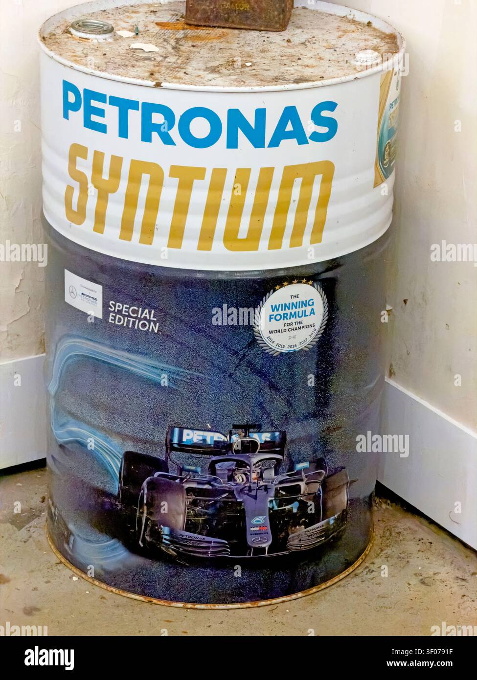 Limited-edition PETRONAS Syntium oil drum featuring a black Mercedes-AMG PETRONAS Formula One car and Winning Formula branding. Stock Photo
