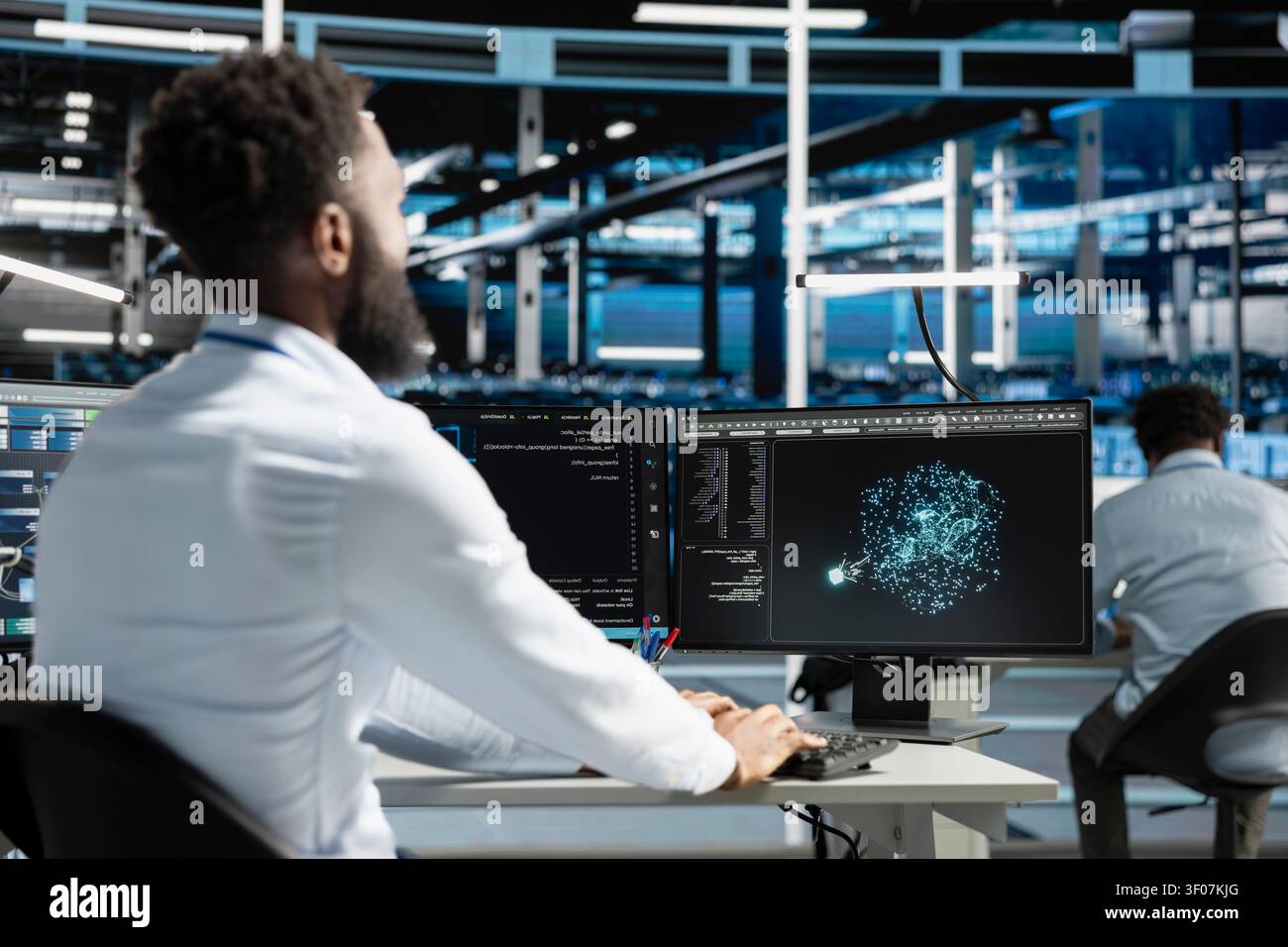 System administrator works with computer in a data center to support data processing, analytics, and storage infrastructure. Stock Photo