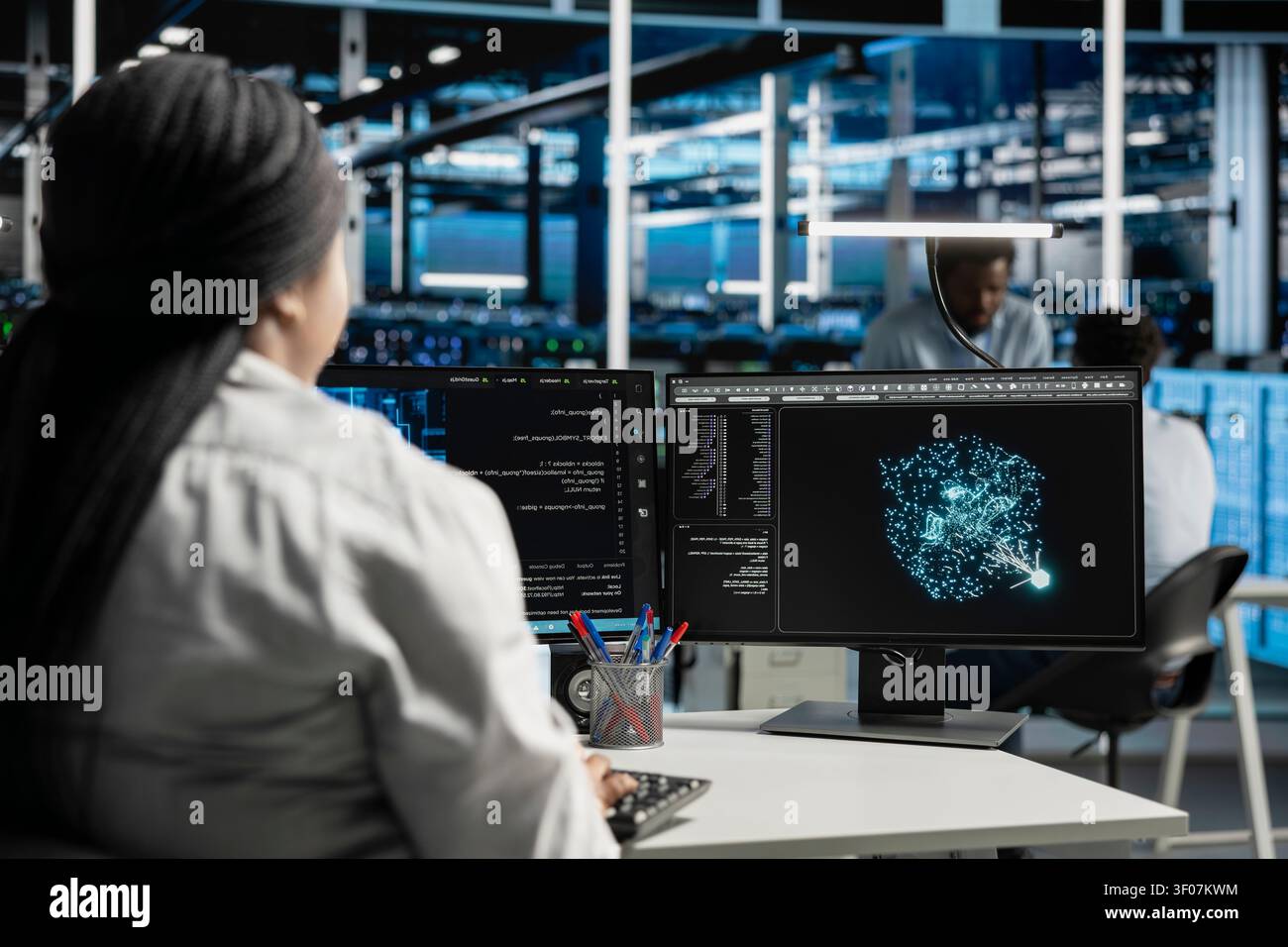 Computer scientist uses machine learning algorithms in a server room to analyze datasets and recognize data patterns. Stock Photo