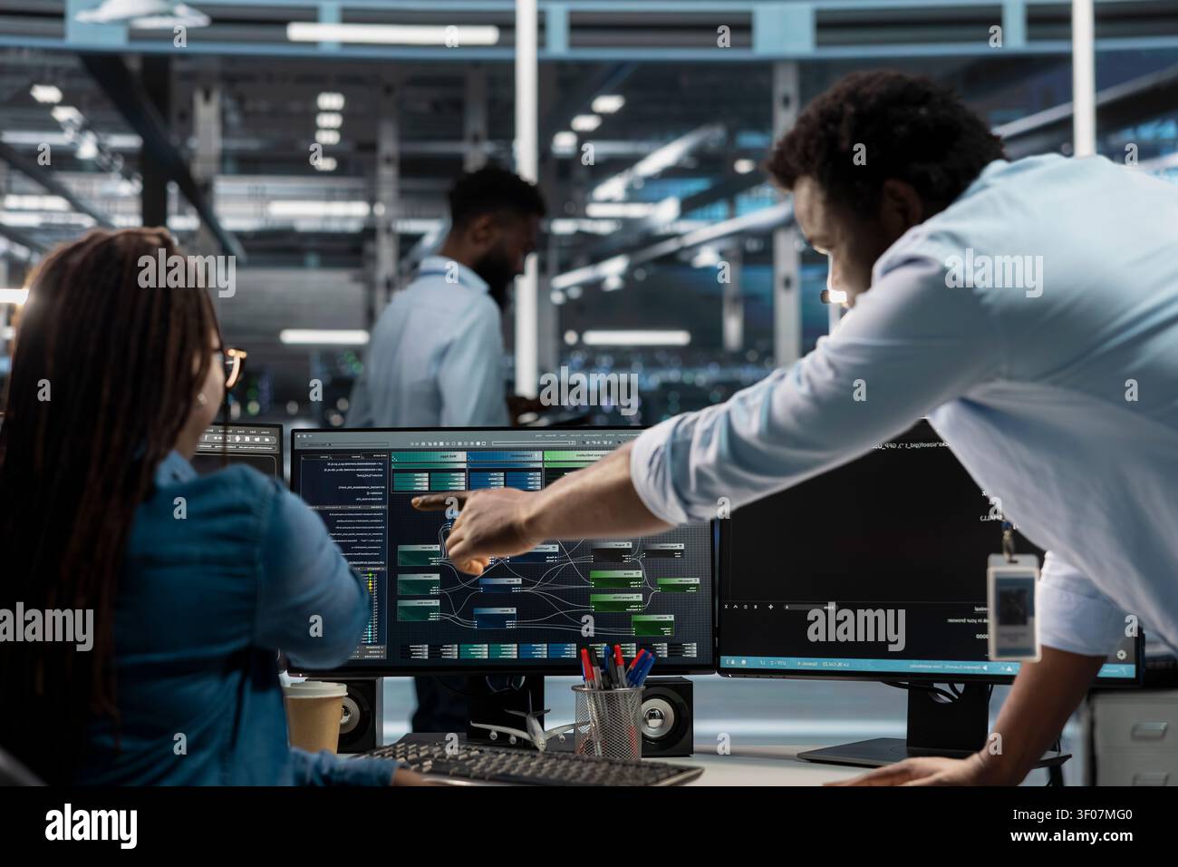 Data center manager reviews node tree software to analyze datasets and improve server infrastructure performance. Stock Photo