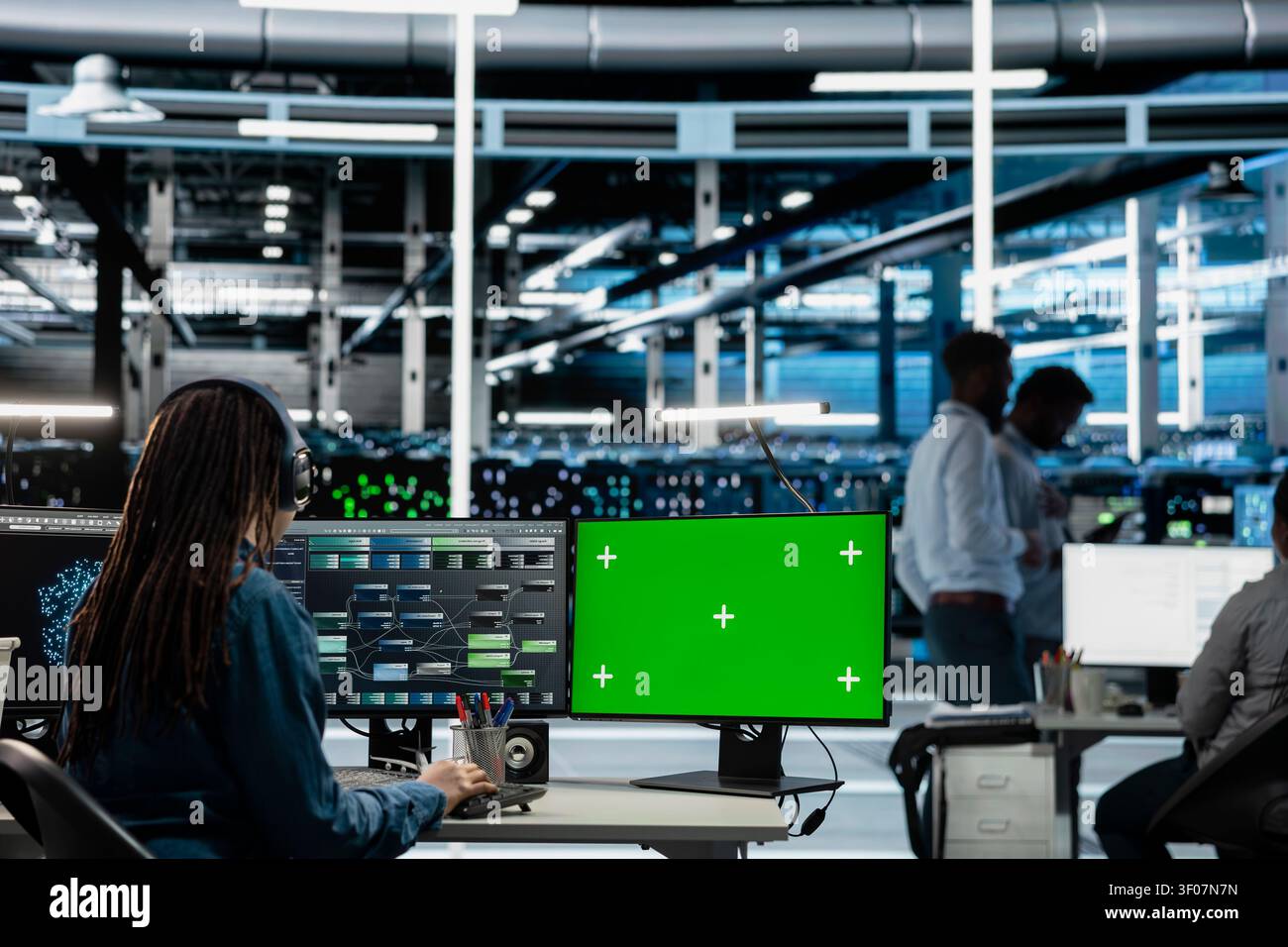 Data center engineer works with a chroma key computer, using an editable screen to repair technical issues. Stock Photo