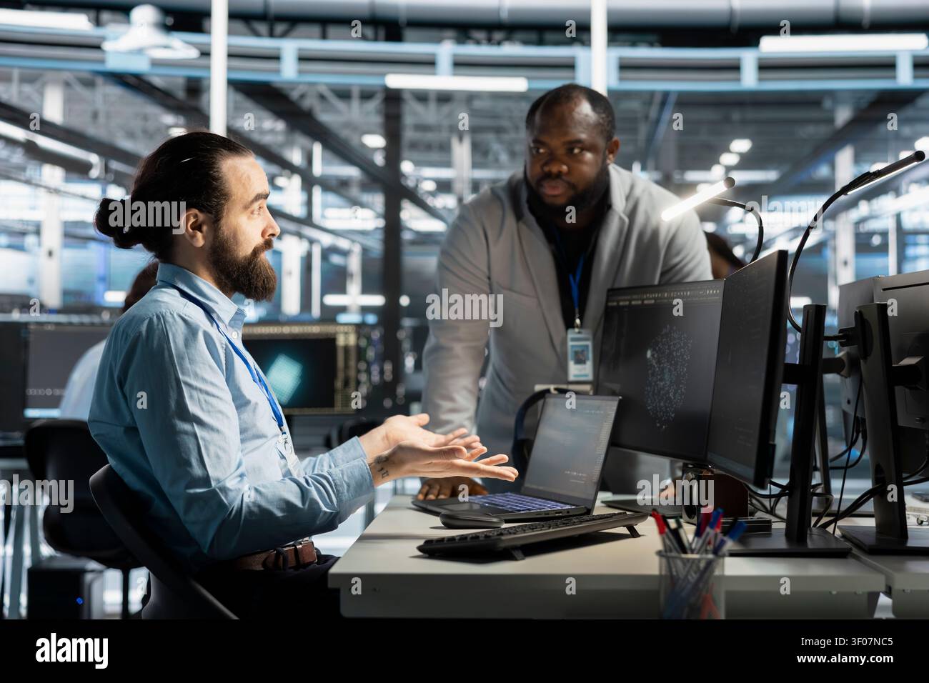 Team of workstation scientists working with workstation in server environment, analyzing data. Stock Photo