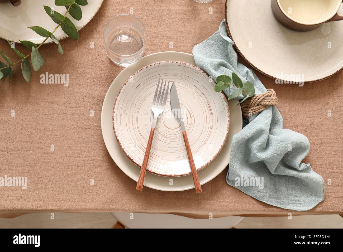 Rustic table setting with plates and cutlery Stock Photo