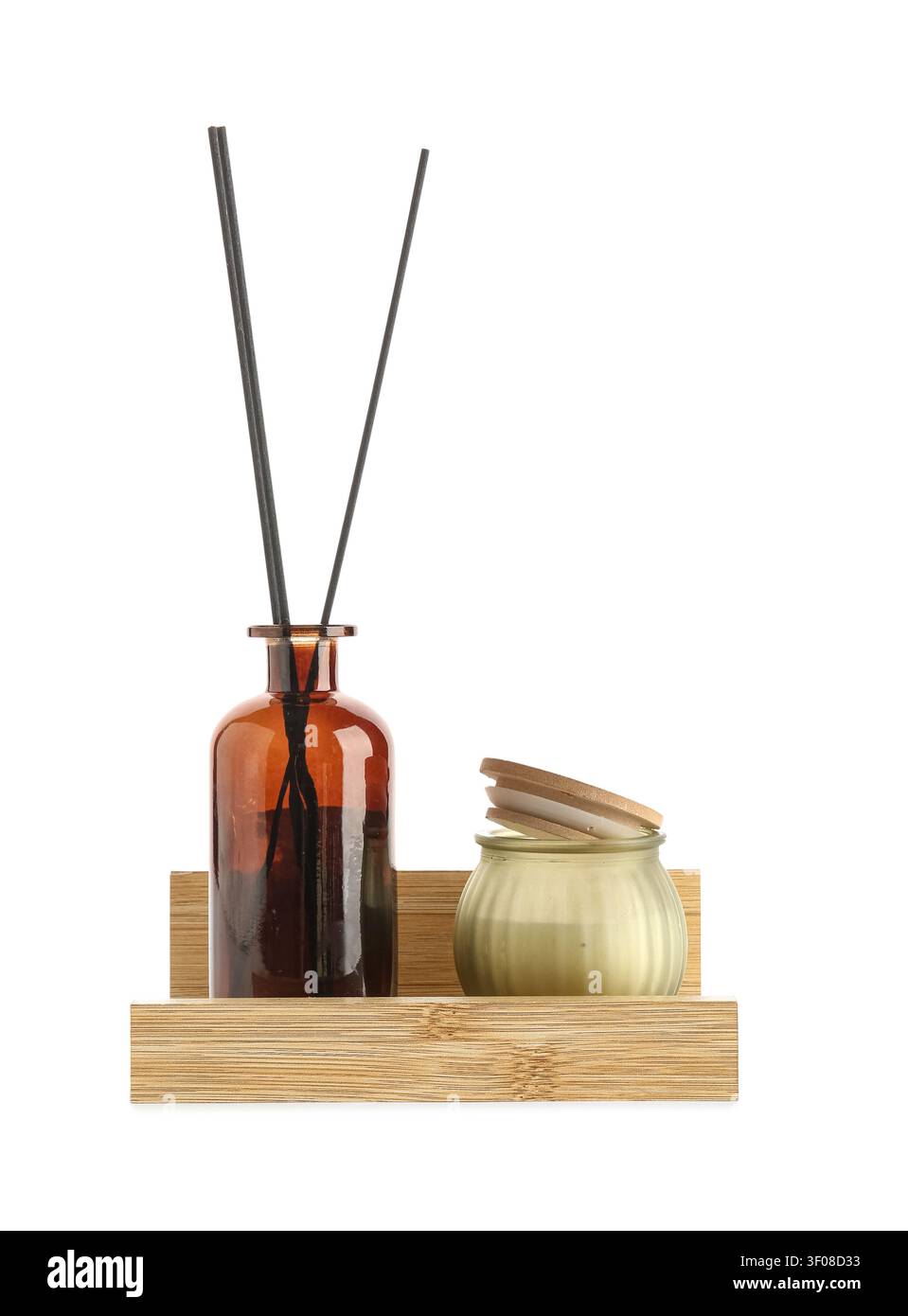 Aromatic reed diffuser and scented candle on wooden tray Stock Photo