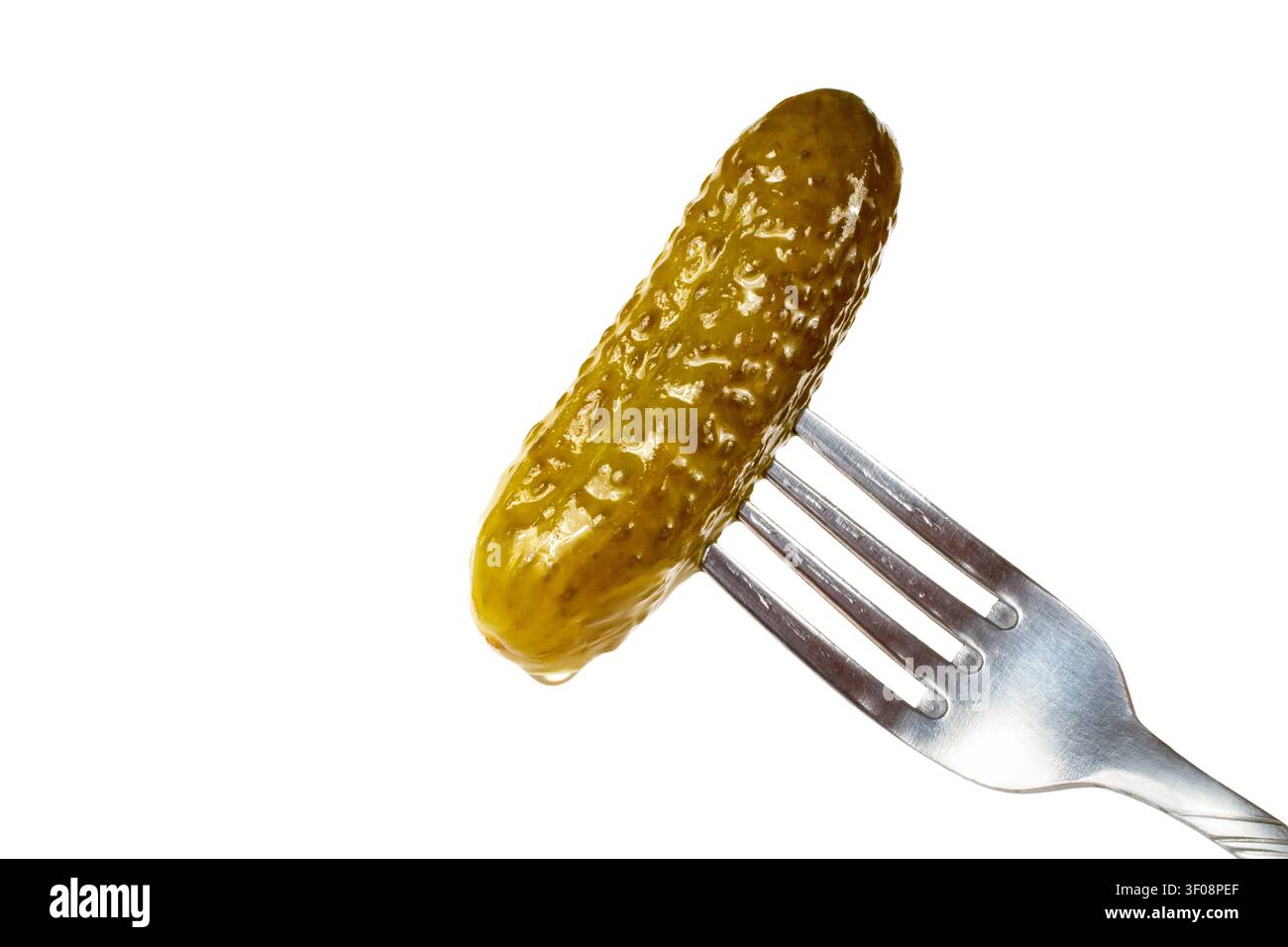 Pickled cucumber on a fork. Pickled cucumber on a white background. Stock Photo