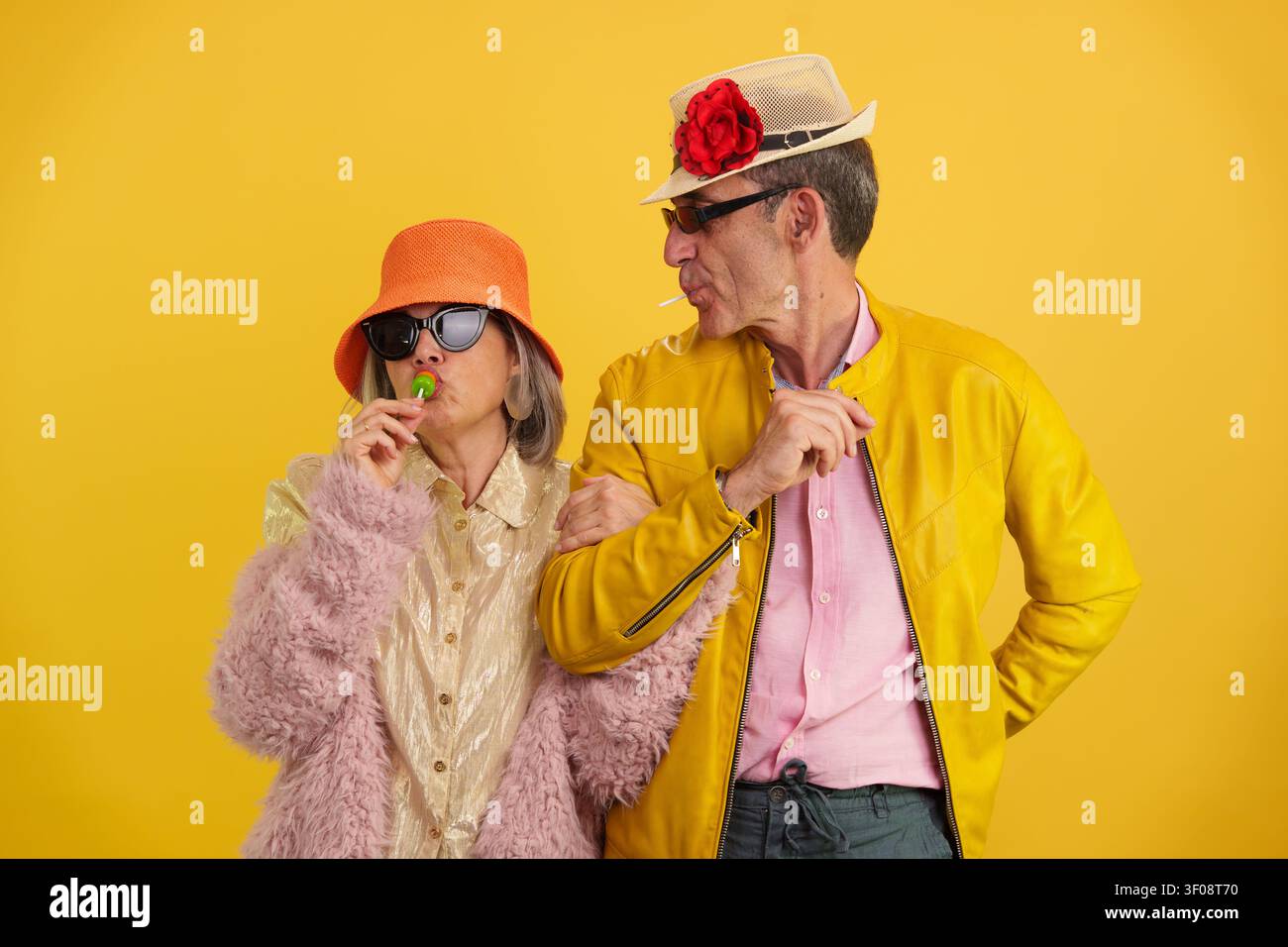 Mature couple enjoying lollipops and having fun Stock Photo