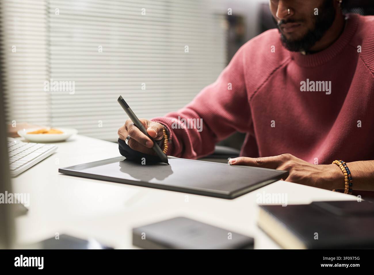 Man Using Graphic Tablet for Digital Design Work Stock Photo