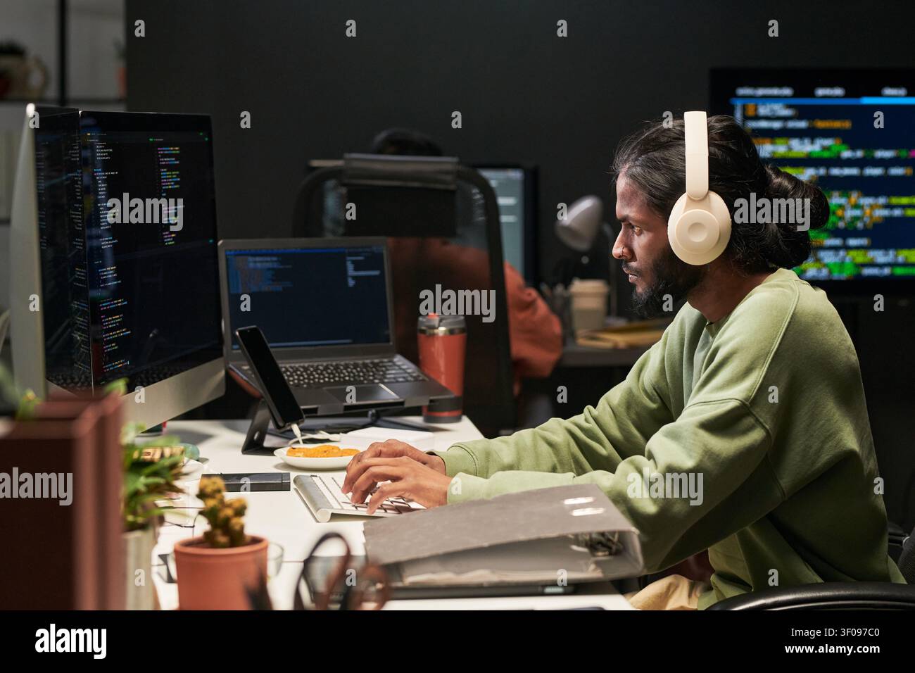 Man Coding at Desk in Software Development Office Stock Photo