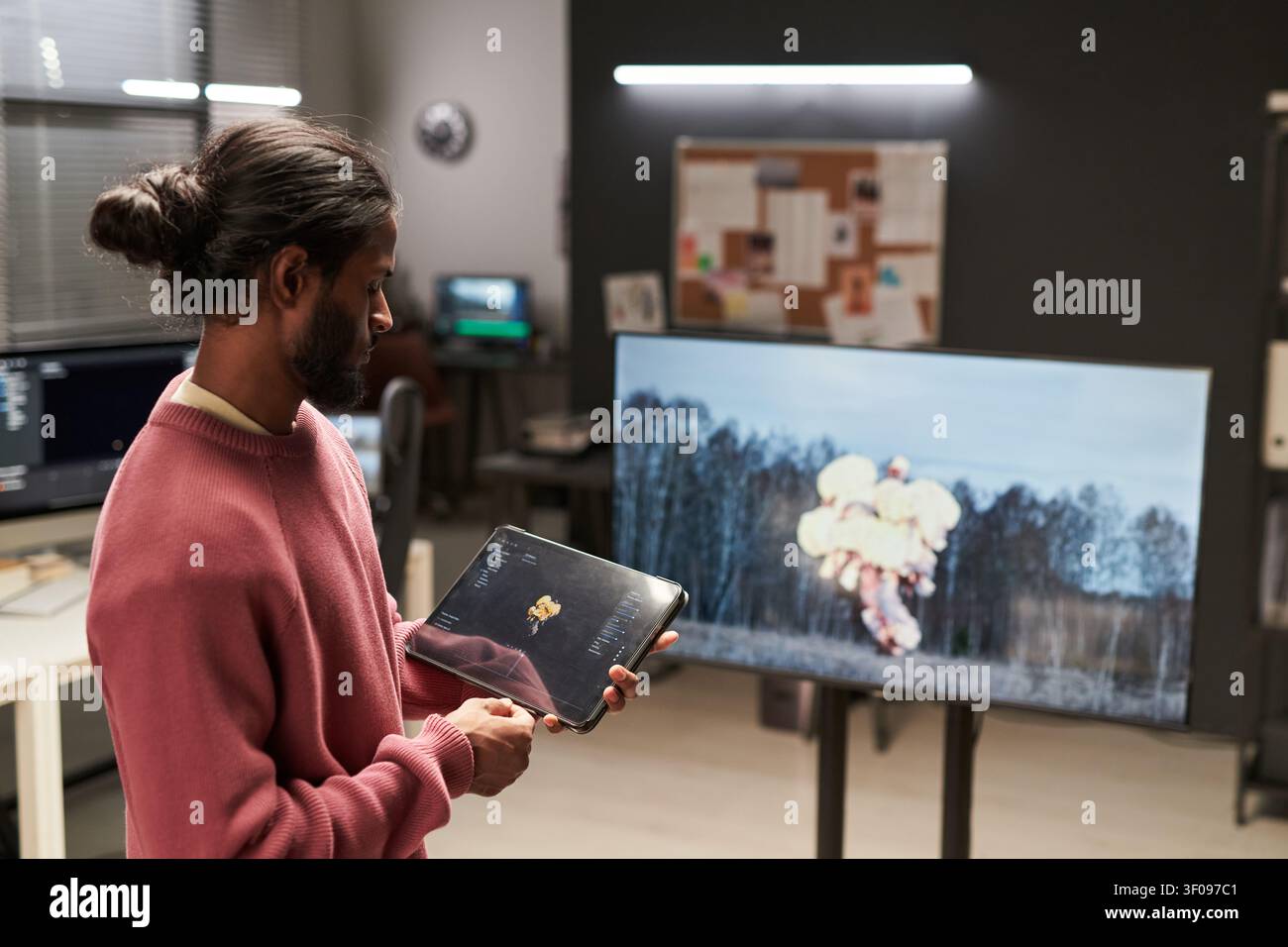 Man Reviewing Visual Effects Content on Tablet in Studio Stock Photo