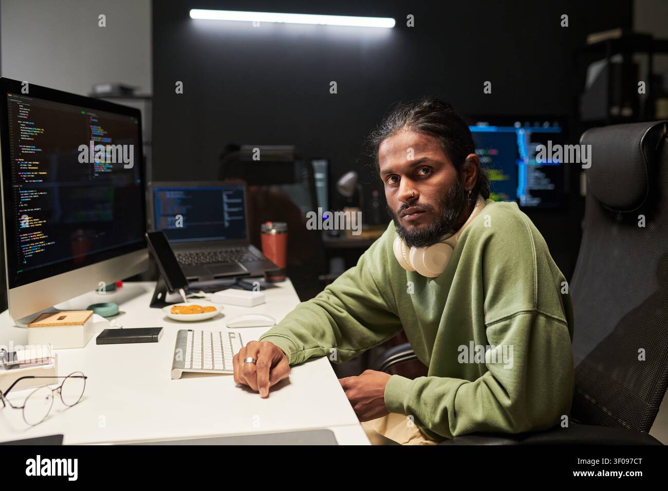 Portrait of Man Coding at Desk in Software Development Stock Photo