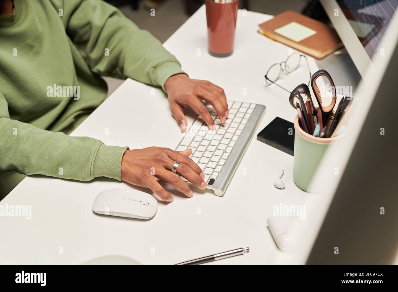 Unknown Man Typing on Keyboard in Home Office Workspace Stock Photo