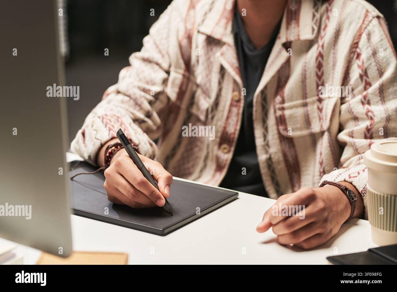 Man Using Graphics Tablet for Digital Design Work Stock Photo