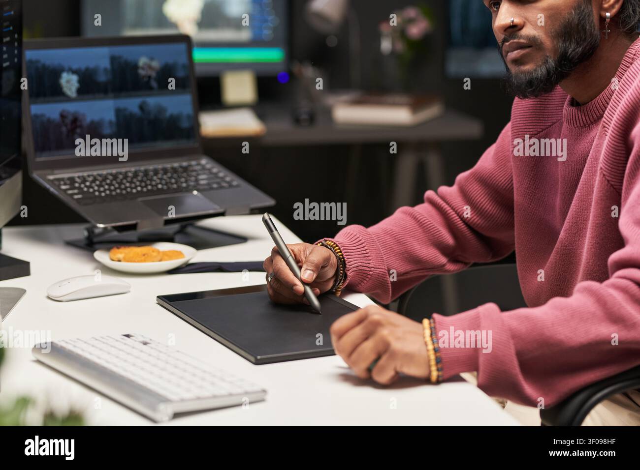 Man Using Graphics Tablet for Creative Remote Work Stock Photo