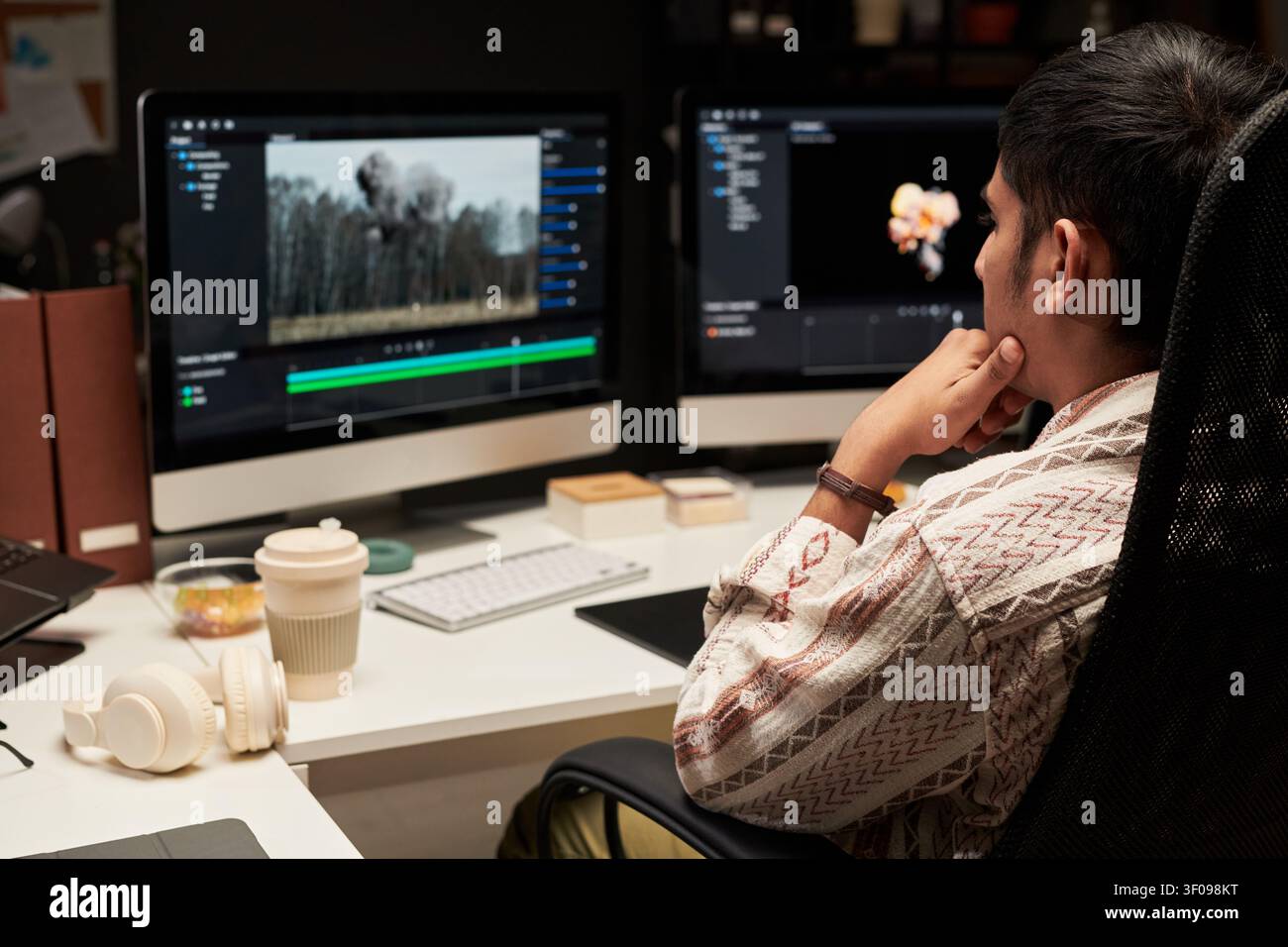 Man Editing Video Content on Desktop for Creative Workflow Stock Photo
