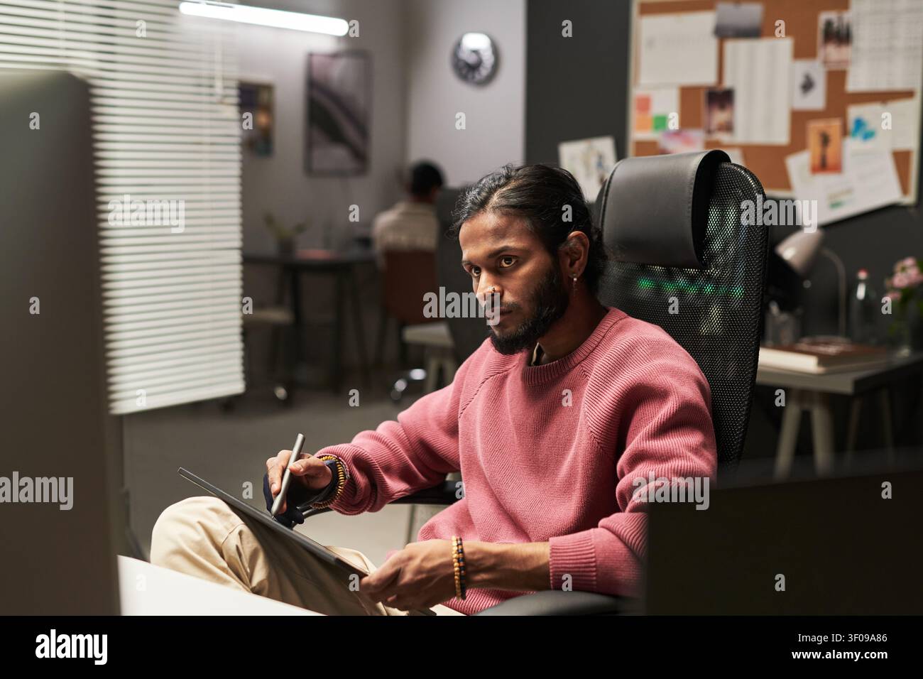 Indian Man Using Graphics Tablet in Creative Office Stock Photo