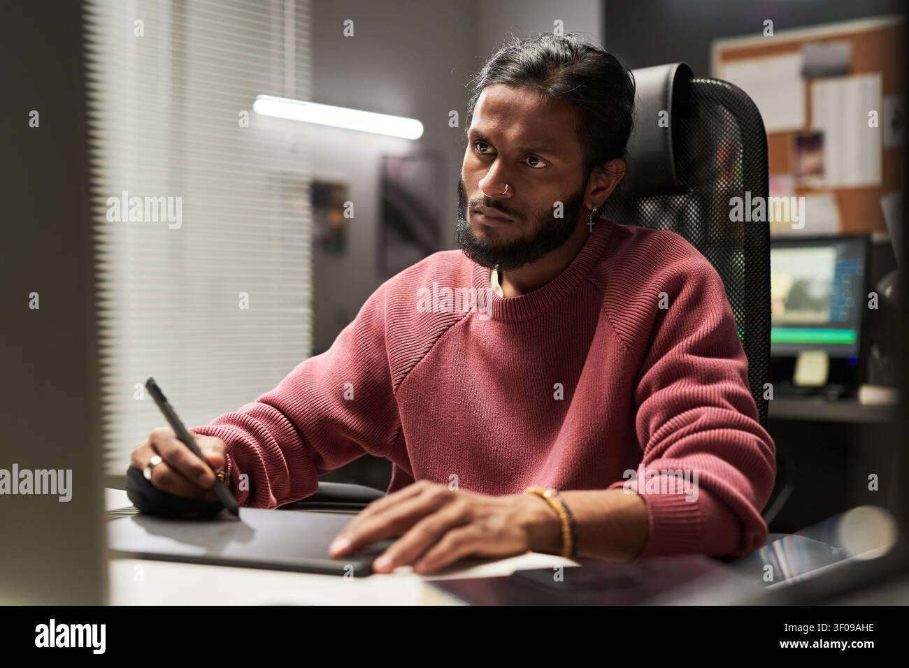 Man Using Graphic Tablet in Creative Office Workspace Stock Photo