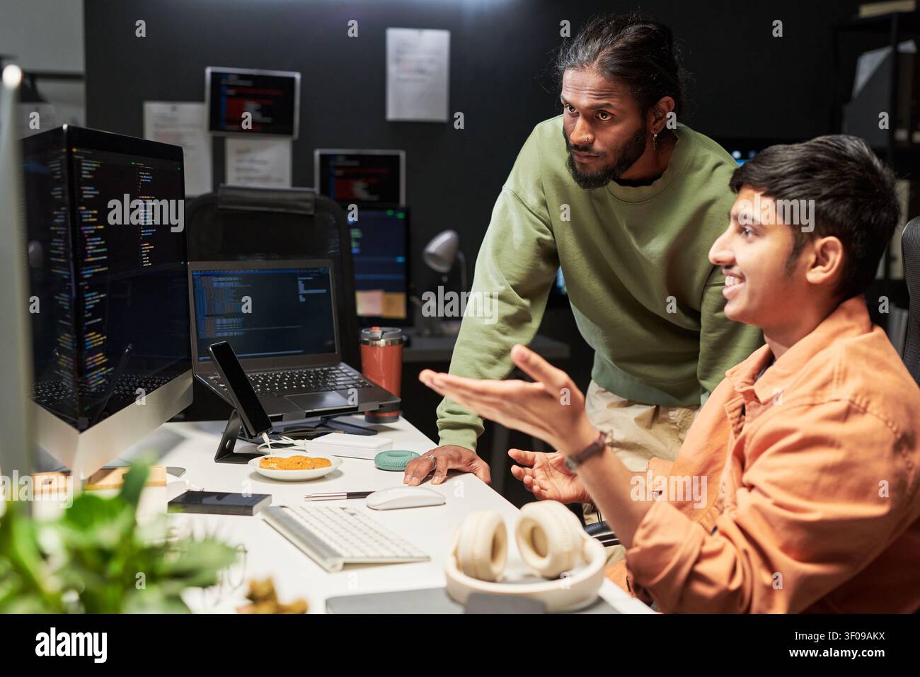 Men Reviewing Software Code in Office Collaboration Stock Photo