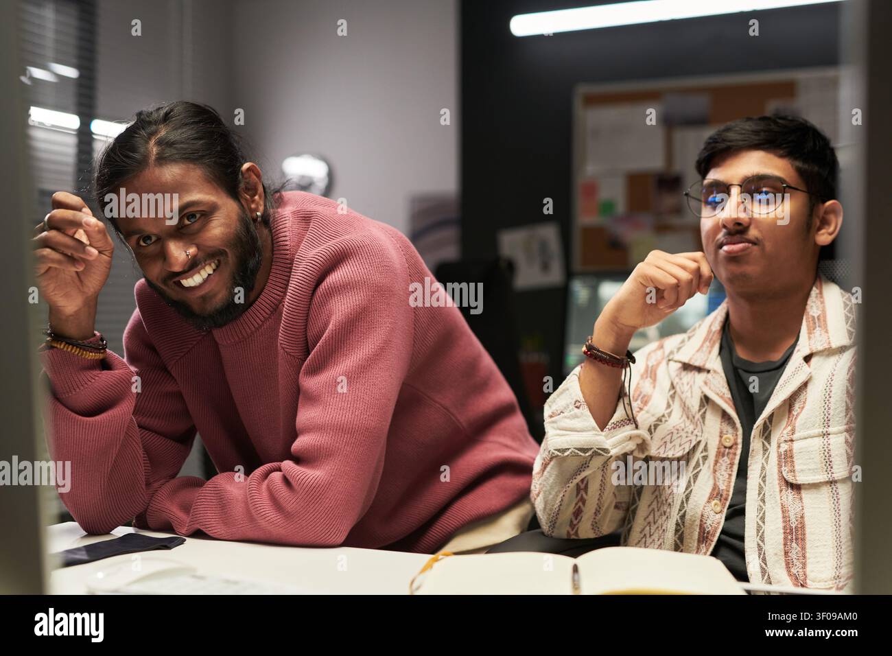Two Young Men Collaborating in Creative Office Stock Photo