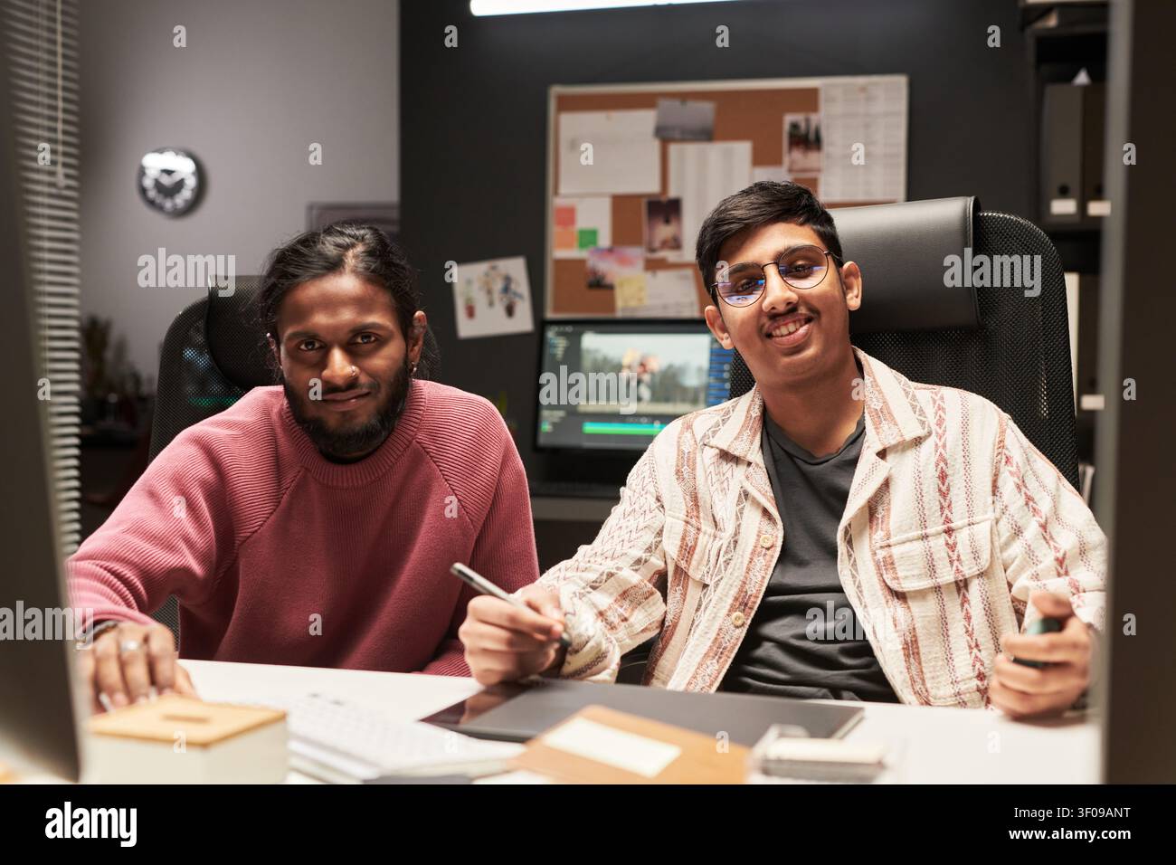 Male Colleagues Collaborating on Video Editing Stock Photo