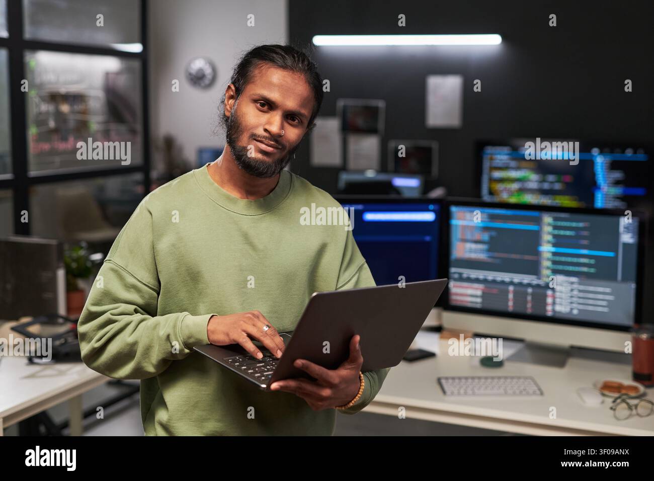 Portrait of Web Engineer Using Laptop in Software Office Stock Photo