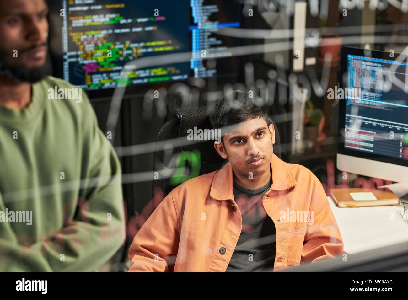 Man Reviewing Code with Team in Software Development Office Stock Photo