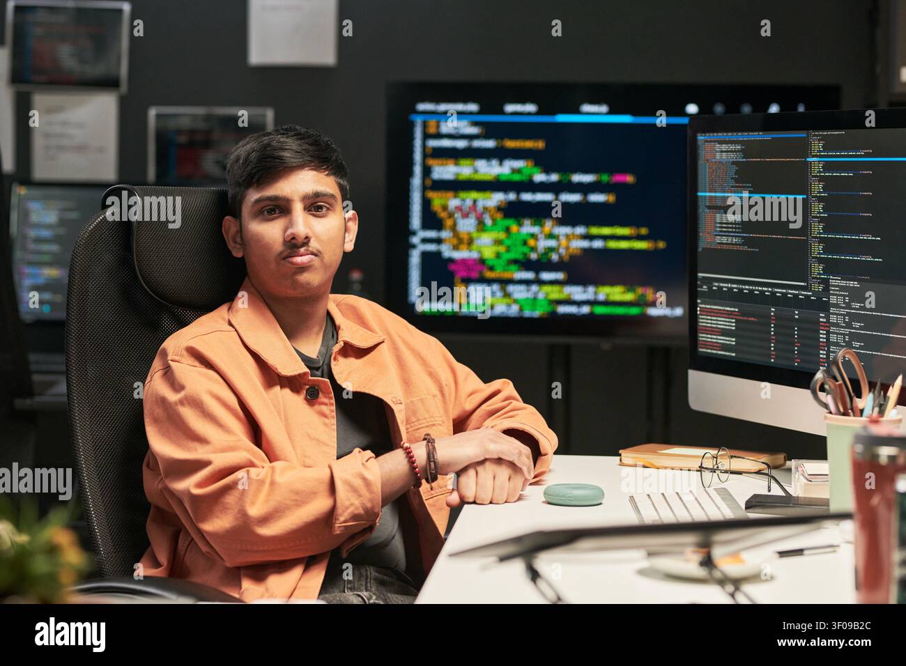 Portrait of Young Man Coding at Software Development Desk Stock Photo