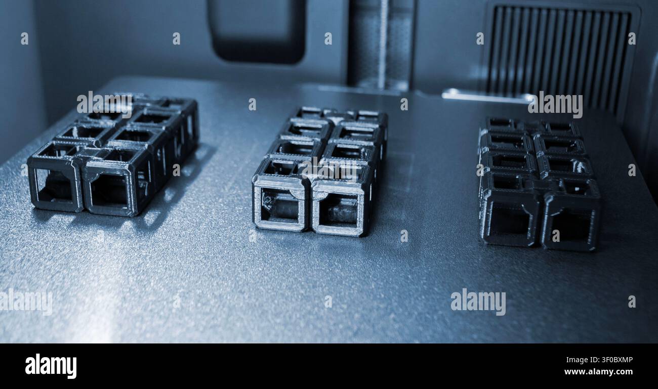 An object printed on a 3D printer on a work surface 3D printer. Object printed on 3D printer from molten plastic black color. Additive new modern manufacturing technology. 3D printing FDM technology Stock Photo