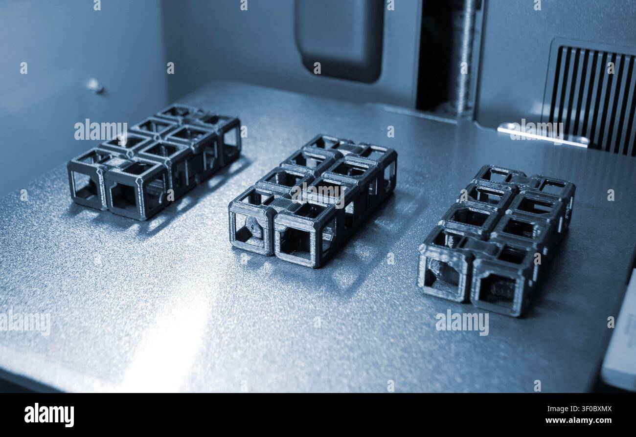An object printed on a 3D printer on a work surface 3D printer. Object printed on 3D printer from molten plastic black color. Additive new modern manufacturing technology. 3D printing FDM technology Stock Photo