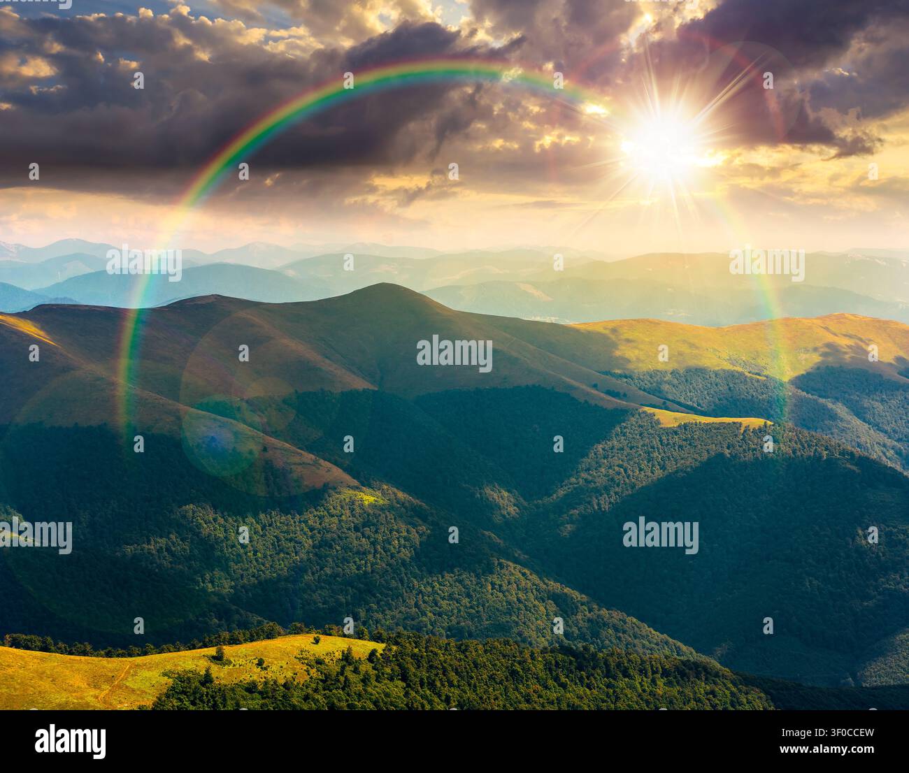 sunset over beautiful mountain landscape in summer. travel ukraine background. rolling hill in dappled light. scenic view of borzhava ridge. carpathia Stock Photo