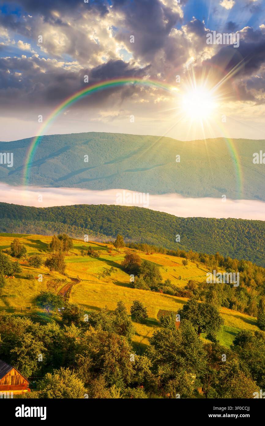 foggy sunset over carpathian mountain landscape. outdoor adventure with stunning view in evening light. mountainous countryside of ukraine in summer. Stock Photo