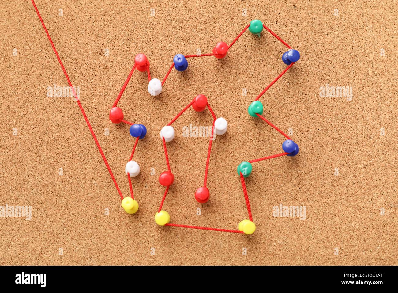 Connected pins with thread on board. Link concept Stock Photo