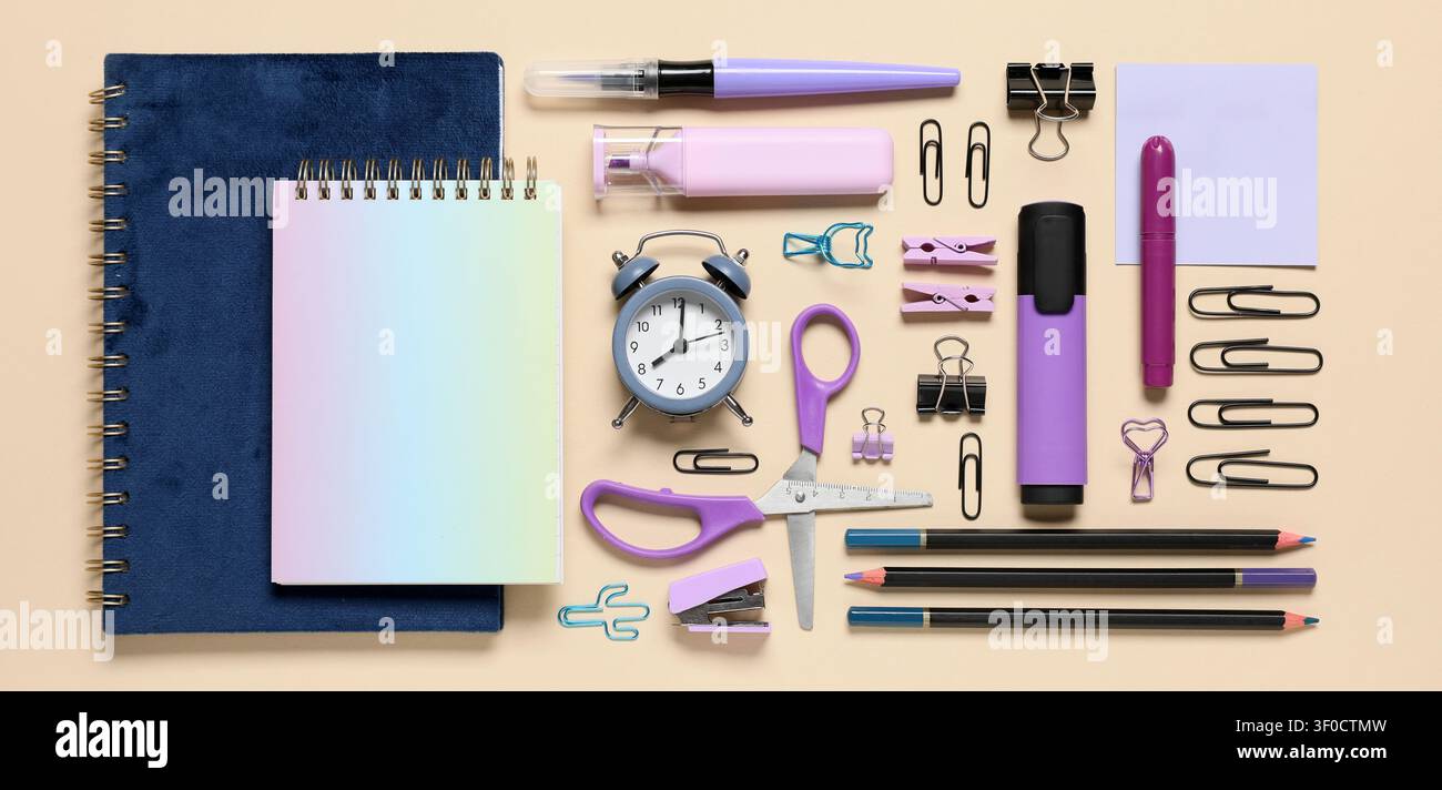 Flat lay of purple and blue office supplies on beige background Stock Photo