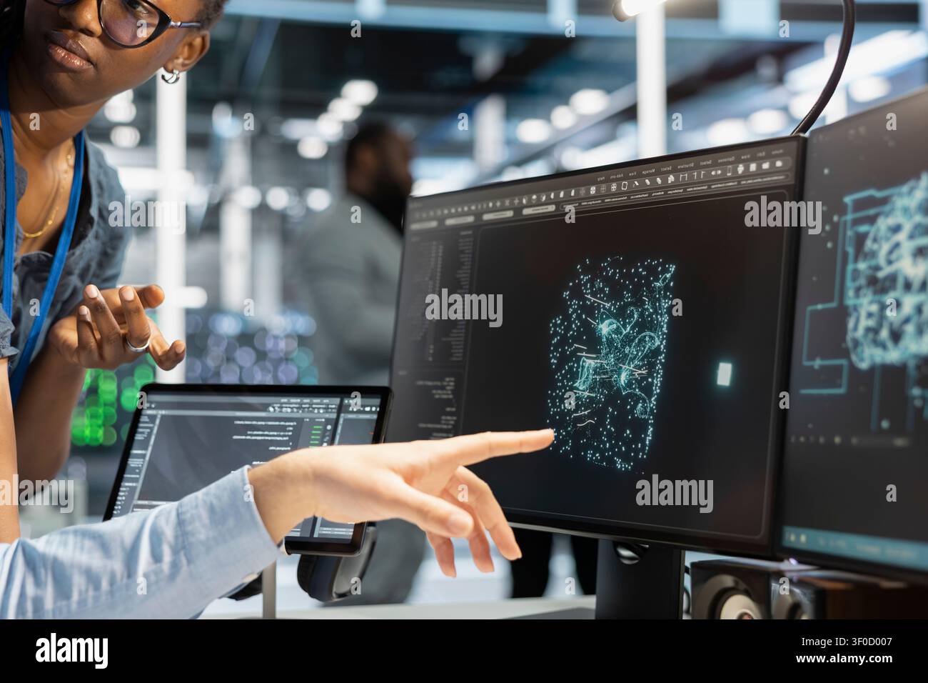 Data center team uses a desktop computer in a data center to manage AI systems and optimize server infrastructure. Stock Photo