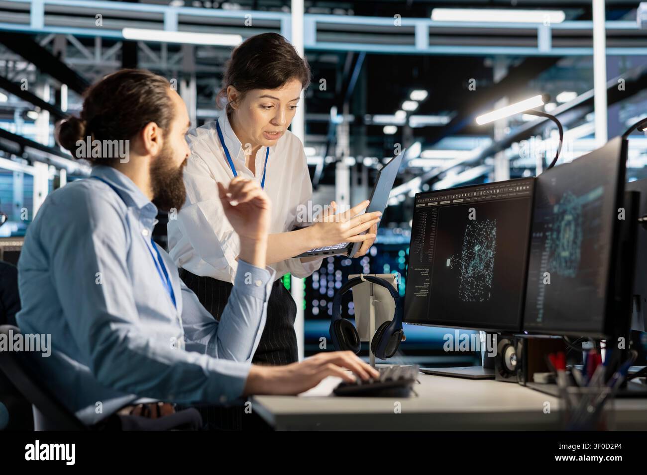 Data center colleagues collaborate on coding and AI automation scripts while reviewing server infrastructure together. Stock Photo