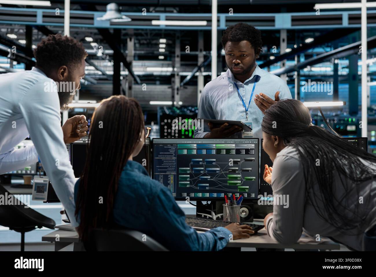 System administrators use a PC in a server farm to visualize AI neural networks and brainstorm while overseeing artificial intelligence systems. Stock Photo