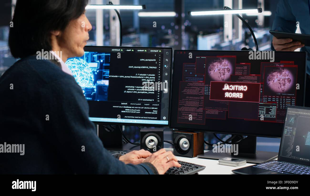 System administrators in server room struggle with computer bugs while working with AI. Stock Photo