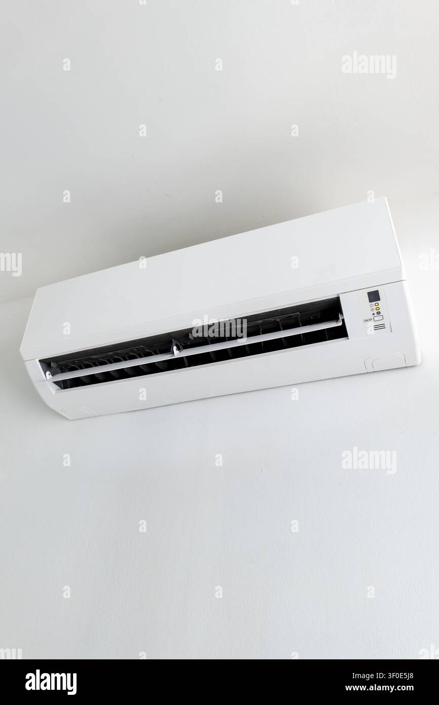 Split system air conditioner mounted on white wall, home cooling appliance Stock Photo