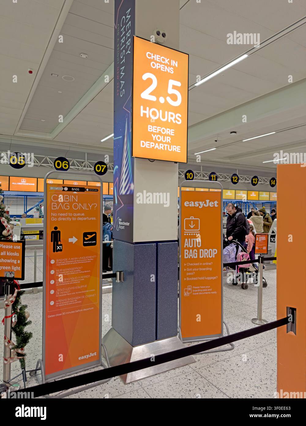 Easyjet warning sign at Manchester Airport auto bag drop - Check-in opens 2.5 hours before your departure Stock Photo