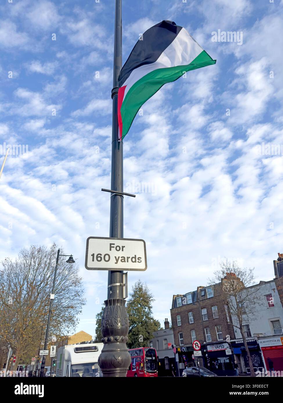 Solidarity - Palestinian flag flying from a lamp post on Grove Road, Mile End, in the London Borough of Tower Hamlets, East London, UK. Stock Photo