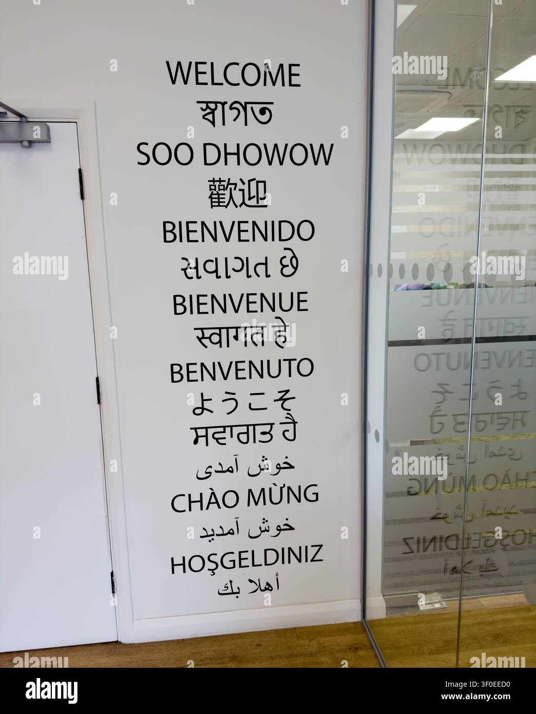 Welcome greetings in multiple languages reflect Tower Hamlets’ diverse community at Gateway Housing Association in Mile End, London Stock Photo