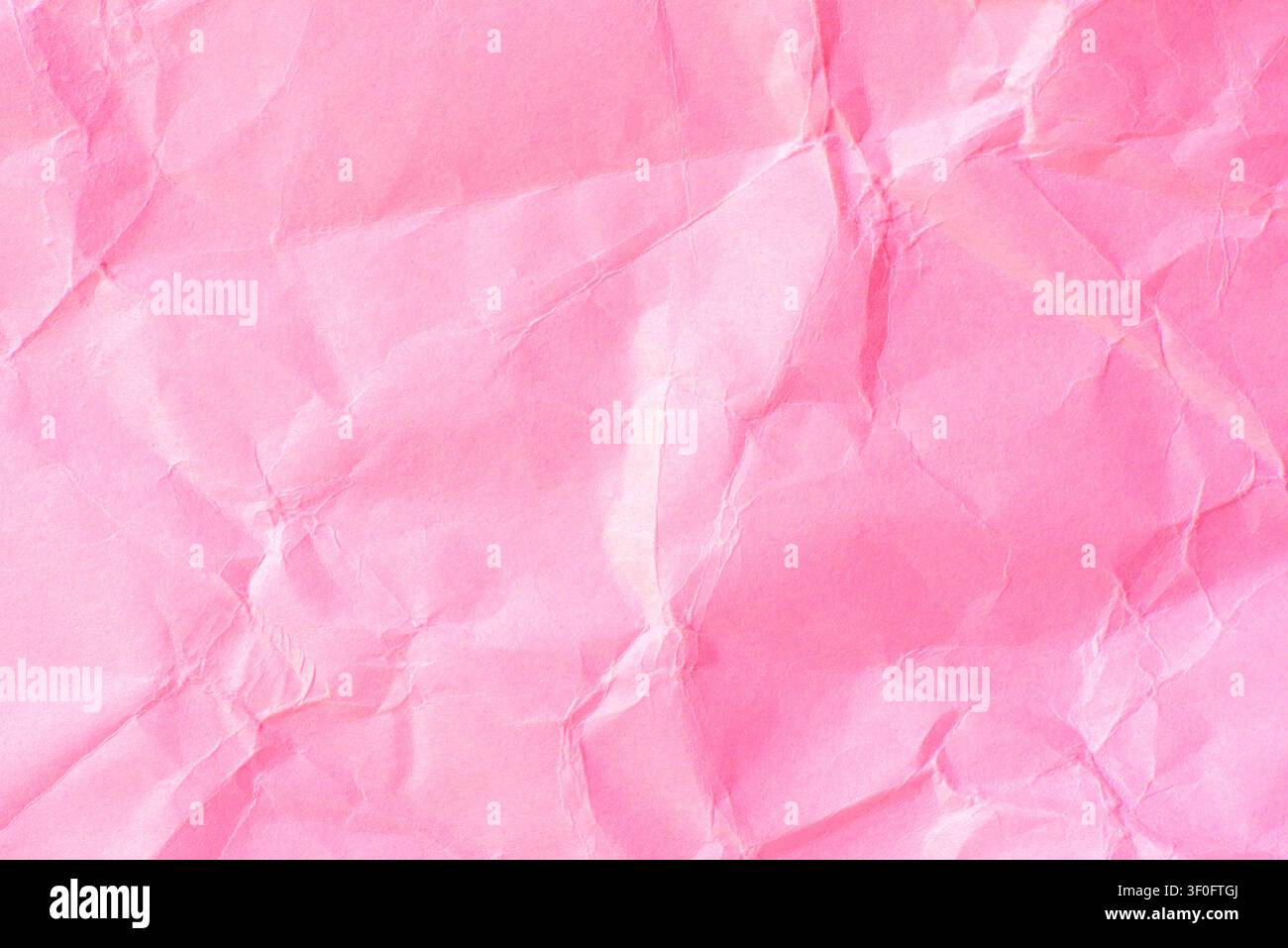 Pink crumpled paper texture background. Stock Photo