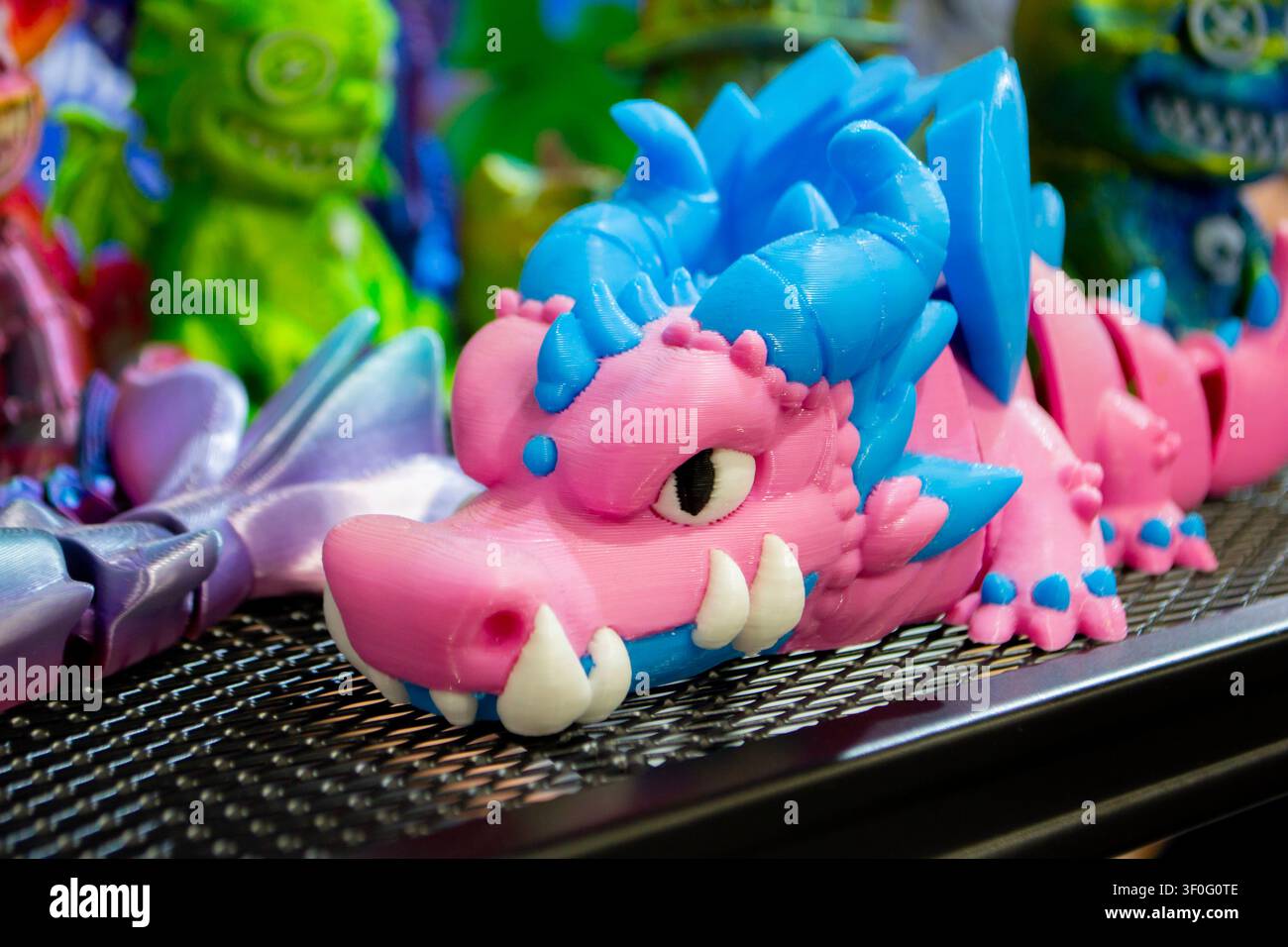 Different colorful toys printed on 3D printer. Art models printed on 3D printer from molten plastic. FDM technology. Fused Deposition Modeling. Additive modern manufacturing technology. 3D printing Stock Photo
