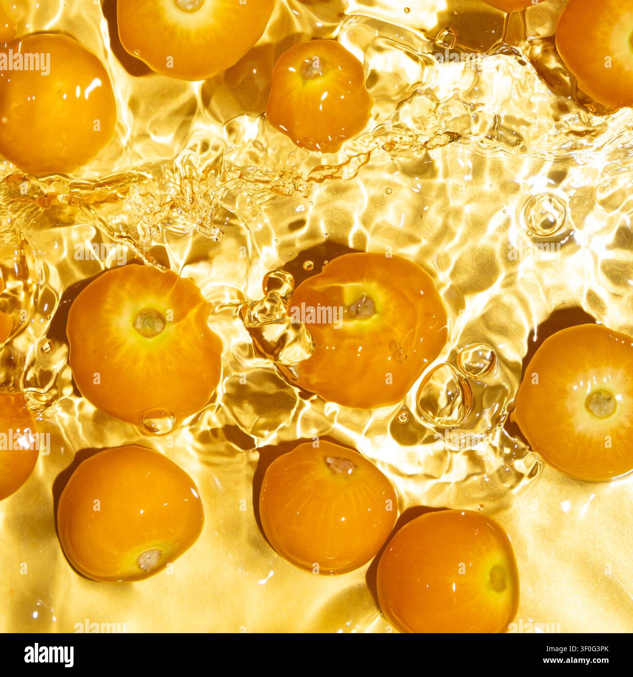 Fresh physalis berries washing in clean water with splashes Stock Photo