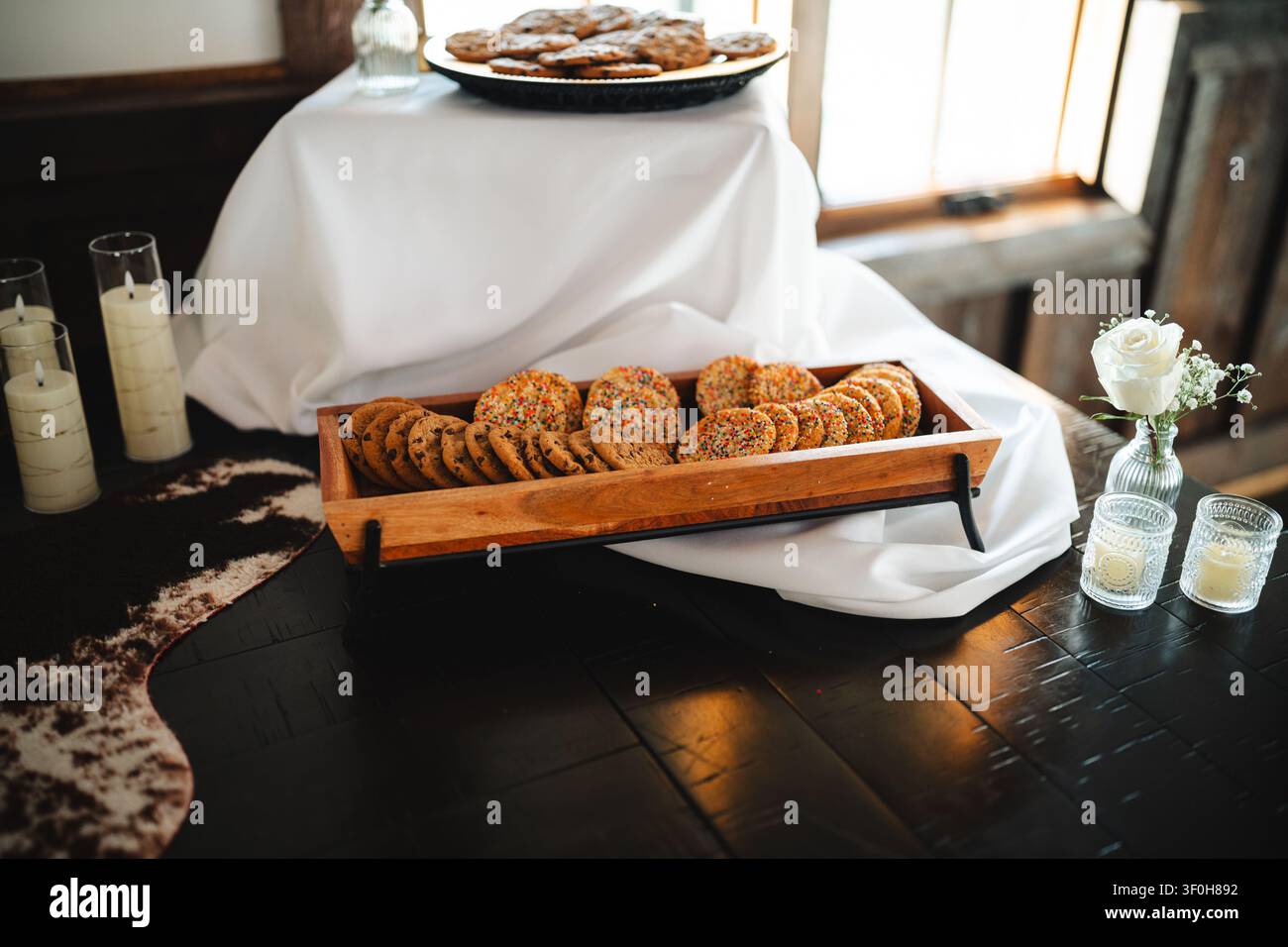 Assorted cookies in wooden tray at elegant dessert buffet Stock Photo
